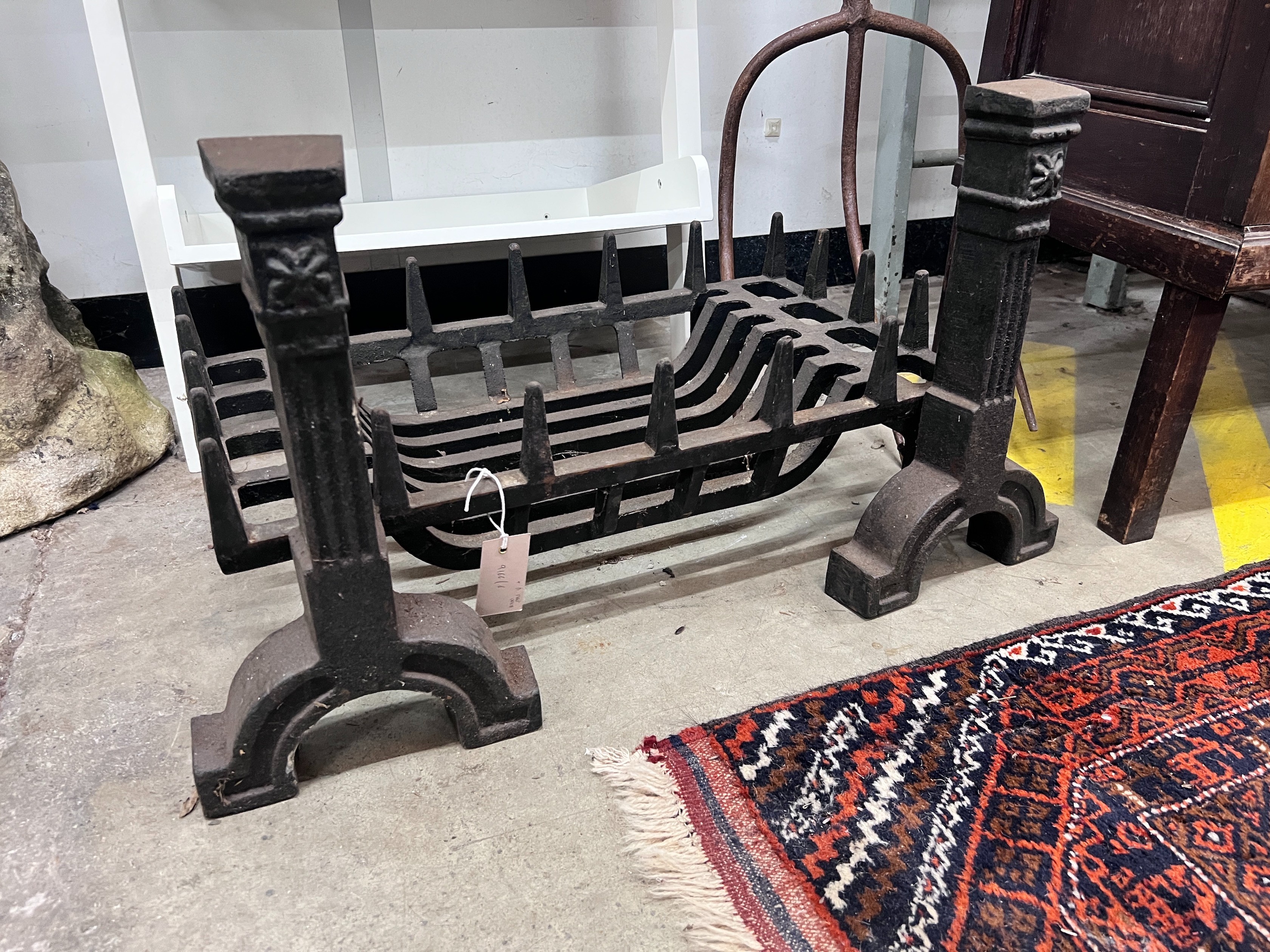 A cast iron fire grate, length 61cm, depth 33cm and a pair of fire dogs *Please note the sale commences at 9am.